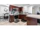 Modern kitchen featuring stainless steel appliances, dark wood cabinetry, and tiled floors at 5113 Sage Way, Kissimmee, FL 34758