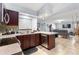 Modern kitchen featuring stainless steel appliances, dark wood cabinetry, and tiled floors at 5113 Sage Way, Kissimmee, FL 34758