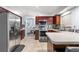 Modern kitchen featuring stainless steel appliances, dark wood cabinetry, and tiled floors at 5113 Sage Way, Kissimmee, FL 34758