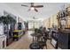 Large living room with laminate flooring, ceiling fans, and ample natural light at 5113 Sage Way, Kissimmee, FL 34758