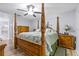 Bedroom with wooden four-poster bed, ceiling fan, and neutral colored walls at 5113 Sage Way, Kissimmee, FL 34758