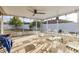 Screened-in patio featuring outdoor seating and views of the backyard at 5113 Sage Way, Kissimmee, FL 34758