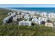 Panoramic aerial view of a condo community on the coast, surrounded by lush greenery and water features at 5300 S Atlantic Ave # 16-505, New Smyrna Beach, FL 32169