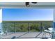 Wide-angle balcony with scenic view of green landscape, blue railings, and outdoor seating at 5300 S Atlantic Ave # 16-505, New Smyrna Beach, FL 32169