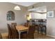 Charming dining area with kitchen access and a lovely decorative mirror at 5300 S Atlantic Ave # 16-505, New Smyrna Beach, FL 32169