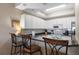 Bright kitchen boasts a breakfast bar with seating, granite counters, white cabinetry, and stainless steel appliances at 5300 S Atlantic Ave # 16-505, New Smyrna Beach, FL 32169