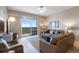 Bright living room with balcony access, comfortable seating, and modern decor at 5300 S Atlantic Ave # 16-505, New Smyrna Beach, FL 32169