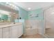 Bright main bathroom features a corner tub, walk-in shower, and vanity with ample counter space and storage at 5300 S Atlantic Ave # 16-505, New Smyrna Beach, FL 32169