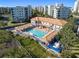 Aerial view of a community pool area with patio furniture, shady seating and attractive landscaping at 5300 S Atlantic Ave # 16-505, New Smyrna Beach, FL 32169