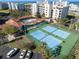 Aerial view of the tennis and bocce ball courts along with a community pool and clubhouse at 5300 S Atlantic Ave # 16-505, New Smyrna Beach, FL 32169