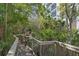 Wooden walkway winding through a lush, green natural landscape near the building at 5300 S Atlantic Ave # 16-505, New Smyrna Beach, FL 32169