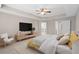 Bright main bedroom featuring a ceiling fan and tray ceiling at 540 Seven Oaks Blvd, Winter Springs, FL 32708