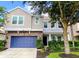 Charming two-story home with a blue garage door and beautifully landscaped front yard at 540 Seven Oaks Blvd, Winter Springs, FL 32708