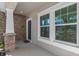 Welcoming front porch featuring brick accents, a cozy entrance, and windows at 540 Seven Oaks Blvd, Winter Springs, FL 32708