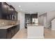 Spacious kitchen with dark cabinets, granite countertops, and a functional island at 540 Seven Oaks Blvd, Winter Springs, FL 32708