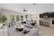 Open-concept living area featuring stylish furniture and an adjacent modern kitchen at 540 Seven Oaks Blvd, Winter Springs, FL 32708