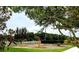 Well-maintained community playground with swings, a slide, and a see-saw in a grassy area at 540 Seven Oaks Blvd, Winter Springs, FL 32708