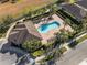 Aerial view of a community pool with lounge chairs, palm trees, and well-maintained landscaping at 540 Seven Oaks Blvd, Winter Springs, FL 32708