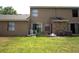 Spacious backyard featuring a green lawn, a small patio, and rear exterior of the home at 613 Casa Park Court B N Ct # B, Winter Springs, FL 32708