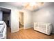 Bedroom featuring wood floors, neutral walls, and a crib at 613 Casa Park Court B N Ct # B, Winter Springs, FL 32708