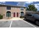 Townhouse exterior featuring two-stories, two front doors, a tan exterior, and nearby parking spaces at 613 Casa Park Court B N Ct # B, Winter Springs, FL 32708