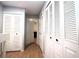 Hallway with multiple storage closets and wood-look flooring providing ample space and organization at 613 Casa Park Court B N Ct # B, Winter Springs, FL 32708