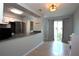 Open kitchen featuring stainless steel appliances, light gray walls, and a breakfast bar with view to the dining area at 613 Casa Park Court B N Ct # B, Winter Springs, FL 32708