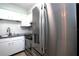 Bright kitchen featuring stainless steel appliances, white cabinets, and tile backsplash at 613 Casa Park Court B N Ct # B, Winter Springs, FL 32708