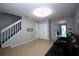 Open-concept living area with tile flooring, view of stairs, and a comfortable seating area with an entertainment center at 613 Casa Park Court B N Ct # B, Winter Springs, FL 32708