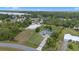 Aerial shot showcasing the property's boundaries, featuring a well-maintained home with a long driveway and lush landscaping at 7017 Bridle Path, St Cloud, FL 34771
