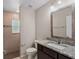 Bathroom featuring granite counters, vanity lighting, and shower at 7017 Bridle Path, St Cloud, FL 34771