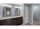 Bathroom featuring a double vanity with granite counters, dark wood cabinetry, and tile floors at 7017 Bridle Path, St Cloud, FL 34771