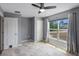 Bedroom with tile flooring, gray walls, ceiling fan, and bright natural light at 7017 Bridle Path, St Cloud, FL 34771