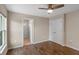 Bright bedroom with wood-look floors, fan, large window and closet access at 7017 Bridle Path, St Cloud, FL 34771