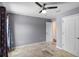 Neutral bedroom featuring tiled floors, ceiling fan, and open closet at 7017 Bridle Path, St Cloud, FL 34771