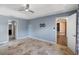 Bedroom with tray ceiling, ceiling fan, tile floor, and access to two doors at 7017 Bridle Path, St Cloud, FL 34771