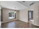 Dining room with wood-look tile flooring, modern chandelier, and a view of the pool at 7017 Bridle Path, St Cloud, FL 34771