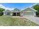Charming one-story home with a well-manicured lawn, two-car garage, and inviting entryway at 7017 Bridle Path, St Cloud, FL 34771