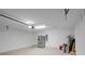 Spacious garage featuring high ceilings, stainless refrigerator, and utility sink at 7017 Bridle Path, St Cloud, FL 34771