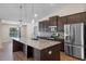 Spacious kitchen with a large island, granite countertops, and stainless steel appliances at 7017 Bridle Path, St Cloud, FL 34771