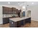 Modern kitchen with granite countertops, stainless steel appliances, and stylish pendant lighting at 7017 Bridle Path, St Cloud, FL 34771