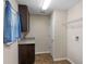 Laundry room featuring cabinetry, granite counters, window, and washer/dryer hookups at 7017 Bridle Path, St Cloud, FL 34771