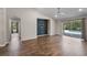 Spacious living area with wood-look tile and a sliding glass door offering access to the pool at 7017 Bridle Path, St Cloud, FL 34771