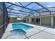 Inviting screened-in pool and spa provide a serene outdoor retreat at 7017 Bridle Path, St Cloud, FL 34771