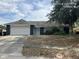 Charming single-story home featuring an attached garage and a cozy front yard in a suburban setting at 7614 Brisbane Ct, Orlando, FL 32835