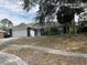 Single-story home featuring a well-manicured front yard, side yard, and attached garage at 7614 Brisbane Ct, Orlando, FL 32835