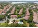 Aerial view of community featuring well-maintained homes, mature trees, and a pool at 8539 Via Bella Notte, Orlando, FL 32836
