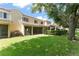 Exterior backyard with manicured hedges, patio area, and a sprawling lawn at 8539 Via Bella Notte, Orlando, FL 32836