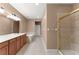 Bathroom with dual sinks, a bathtub, and a glass door shower stall, offering a luxurious feel at 8539 Via Bella Notte, Orlando, FL 32836