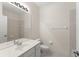 Bright bathroom featuring a large mirror, white vanity, and neutral tile in the shower at 8539 Via Bella Notte, Orlando, FL 32836